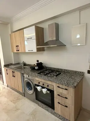 a kitchen with a stove and a washing machine at Moderne appartement centre Marrakech in Marrakech