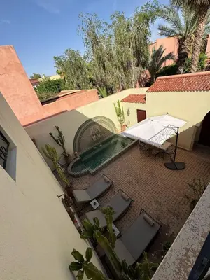 an overhead view of a patio with a table and chairs at Luxury Private Riad, Air-Conditioned and Pool in Marrakech