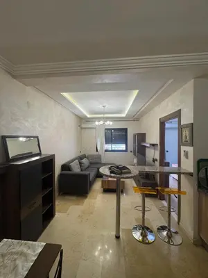 a living room with a couch and a table at Studio au centre ville in Marrakech