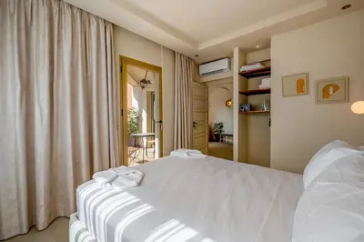 a bedroom with a white bed and a window at Pearl of Guéliz Netflix, Terrace, Quiet in Marrakech