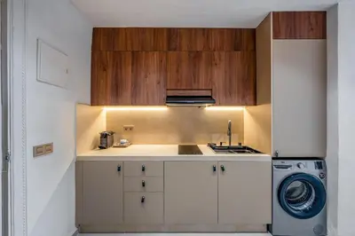 a kitchen with a sink and a washing machine at Pearl of Guéliz Netflix, Terrace, Quiet in Marrakech