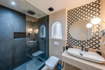 a bathroom with a sink and a toilet and a mirror at Pearl of Guéliz Netflix, Terrace, Quiet in Marrakech