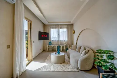 a living room with a couch and a table at Pearl of Guéliz Netflix, Terrace, Quiet in Marrakech