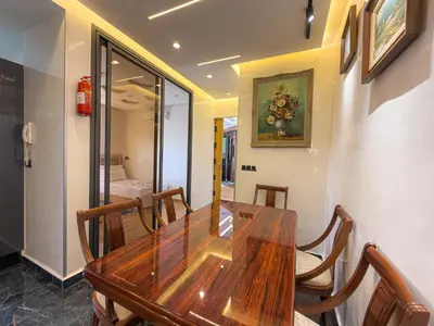 a dining room with a wooden table and chairs at Essalmi Luxury Apartment in Marrakech in Marrakech