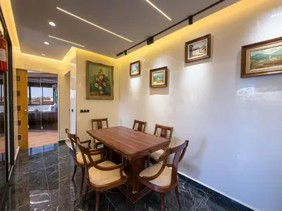 a dining room with a wooden table and chairs at Essalmi Luxury Apartment in Marrakech in Marrakech