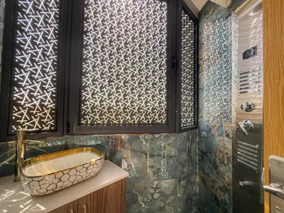 a bathroom with a sink and a wooden cabinet at Essalmi Luxury Apartment in Marrakech in Marrakech