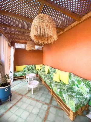 a living room with a green couch and yellow pillows at Riad Privatisé- Riad Dar Farida in Marrakech