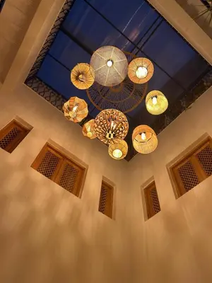 a room with several chandeliers hanging from a ceiling at Riad Privatisé- Riad Dar Farida in Marrakech