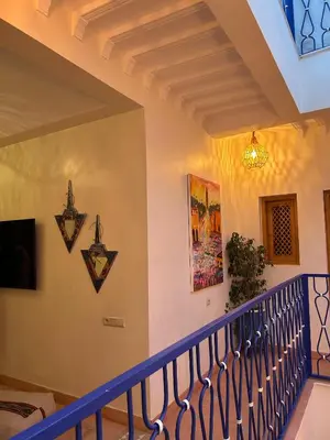 a staircase with blue railings in a house at Riad Privatisé- Riad Dar Farida in Marrakech