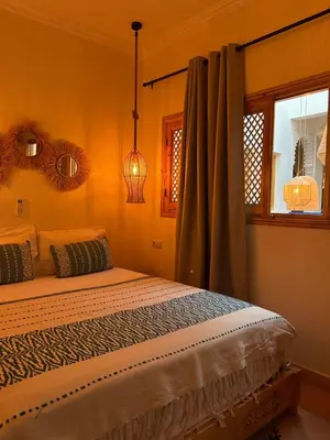 a bedroom with a bed and a window at Riad Privatisé- Riad Dar Farida in Marrakech