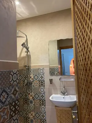 a bathroom with a sink and a mirror at Riad Privatisé- Riad Dar Farida in Marrakech