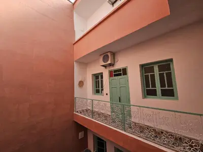 a balcony with a green door on a building at Riad Nomad in Marrakech