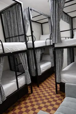 a set of bunk beds in a room with a checkered floor at Riad Nomad in Marrakech