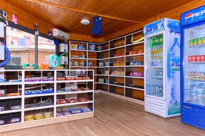 a store with a refrigerator and shelves of food at Luxe et sérénité avec jardin, terrasse et 5 piscines in Marrakech