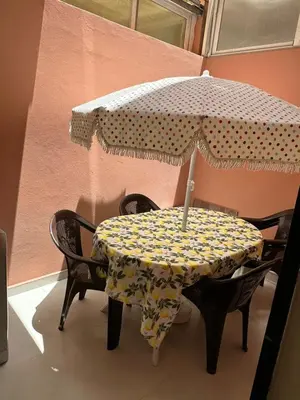 a table with an umbrella on top of it at Exceptionnel appartement a louer in Marrakech