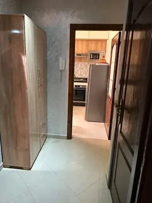 a kitchen with a door open to a kitchen with a refrigerator at Exceptionnel appartement a louer in Marrakech