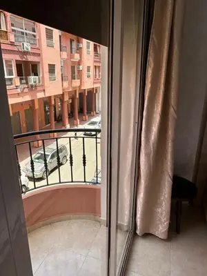 a window with a view of a parking lot at Exceptionnel appartement a louer in Marrakech