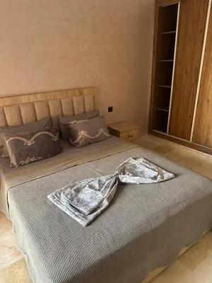 a bedroom with a bed with a robe on it at Pool View Quiet et Comfort in Marrakech