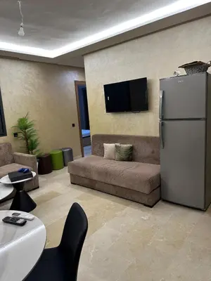 a living room with a couch and a refrigerator at Pool View Quiet et Comfort in Marrakech