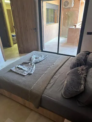 a large bed with a blanket on top of it at Pool View Quiet et Comfort in Marrakech