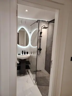 a bathroom with a shower and a sink and a mirror at Majorelle Prestige in Marrakech