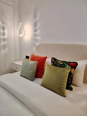 a white bed with four pillows on top of it at Majorelle Prestige in Marrakech