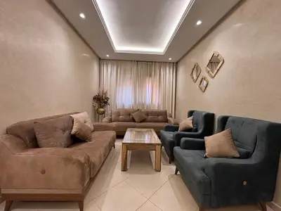 a living room with two couches and a table at La citrine in Marrakech