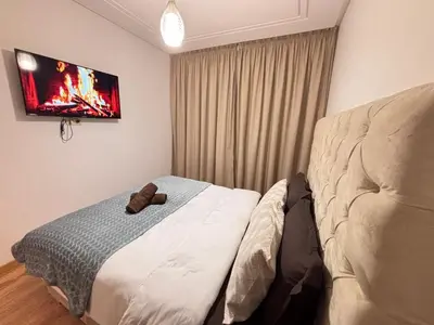 a bedroom with a bed with a teddy bear on it at La citrine in Marrakech