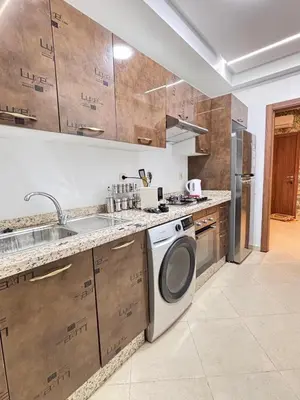 a kitchen with a sink and a washing machine at La citrine in Marrakech
