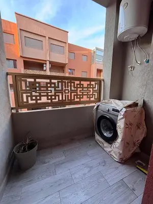 a washing machine sitting on the side of a balcony at La citrine in Marrakech
