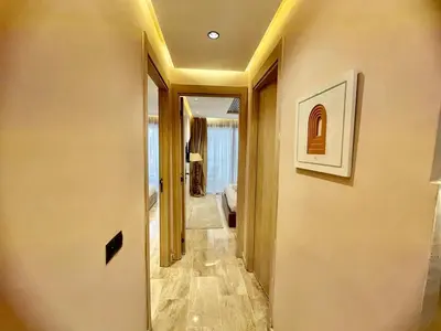 a hallway of a hotel room with a hallway leading to a bathroom at Gueliz Terracotta Stay - 2 BR & Cozy Balcony in Marrakech