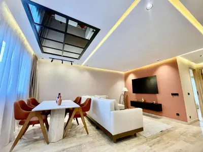 a living room with a couch and a table at Gueliz Terracotta Stay - 2 BR & Cozy Balcony in Marrakech