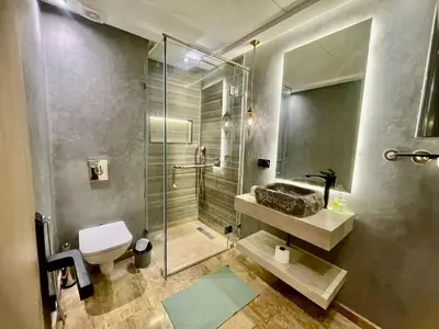 a bathroom with a shower and a toilet and a sink at The Gueliz Escape - 2BR Luxury Flat in Marrakech
