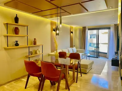 a living room with a table and chairs and a couch at The Gueliz Escape - 2BR Luxury Flat in Marrakech