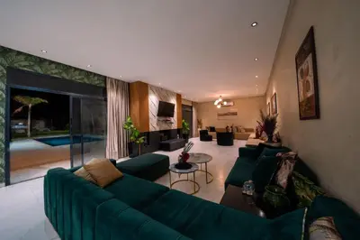 a large living room with a green couch and a table at Viva La Villa in Marrakech