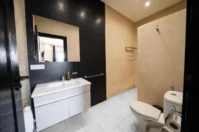 a bathroom with a sink and a toilet and a mirror at Viva La Villa in Marrakech