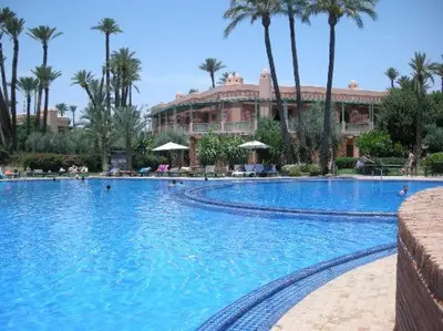 a large swimming pool in front of a resort at Luxury apartement Palmeraie Village in Marrakech