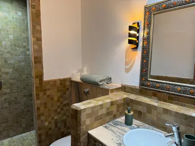 a bathroom with a sink and a mirror at Luxury apartement Palmeraie Village in Marrakech