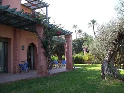 a brick house with a patio with a bike parked outside at Luxury apartement Palmeraie Village in Marrakech