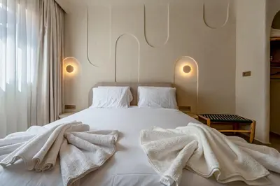 a bedroom with a white bed with white sheets at Modern Haven Guéliz, Netflix, Comfort in Marrakech