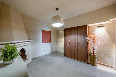 a hallway with a door and a vase with flowers at Modern Haven Guéliz, Netflix, Comfort in Marrakech