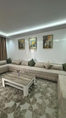 a living room with a couch and a coffee table at Duplex Menara Mall in Marrakech