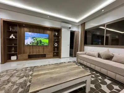 a living room with a couch and a tv at Duplex Menara Mall in Marrakech
