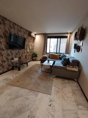 a living room with a couch and a tv at Studio Centre Ville in Marrakech