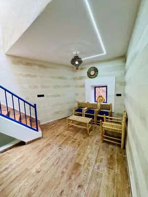 a living room with wooden floors and a ceiling at Maison N 07 in Marrakech