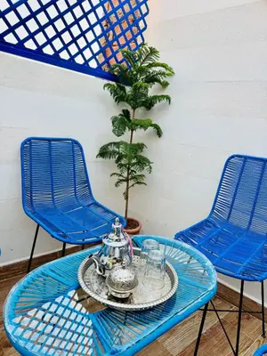 two blue chairs and a table with a tea set at Maison N 07 in Marrakech