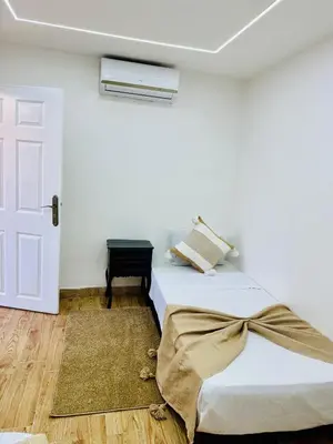 a white room with a bed and a door at Maison N 07 in Marrakech