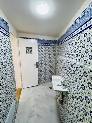 a bathroom with a sink and blue and white tiles at Maison N 07 in Marrakech