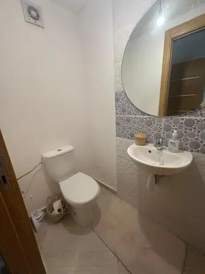 a bathroom with a toilet and a sink and a mirror at Appartement 2 chambre cosy in Marrakech
