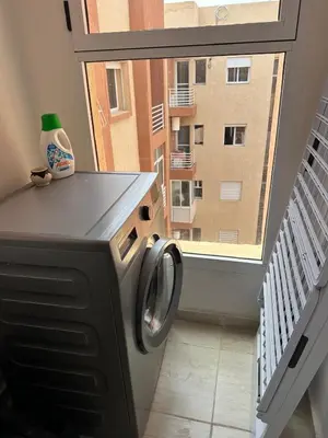 a washing machine in a room with a window at Appartement 2 chambre cosy in Marrakech